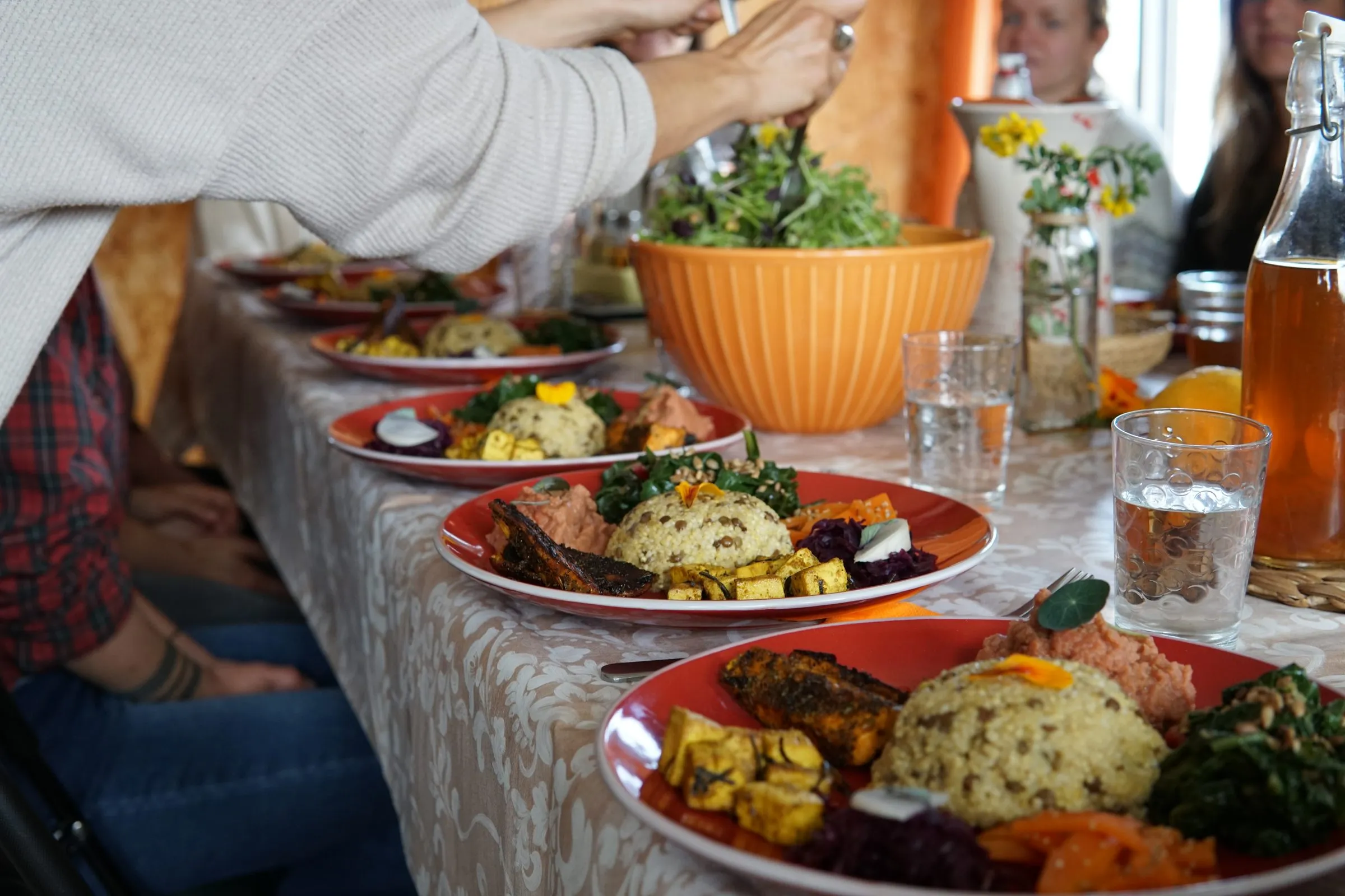 A long table full of colourful dishes