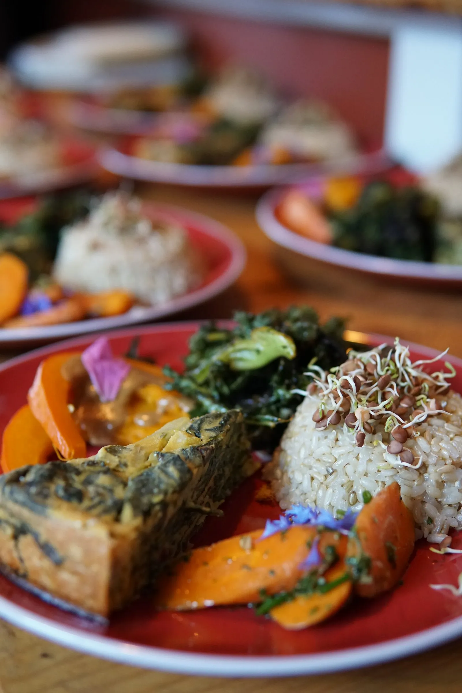 Plates of seasonal food with herbs and flowers